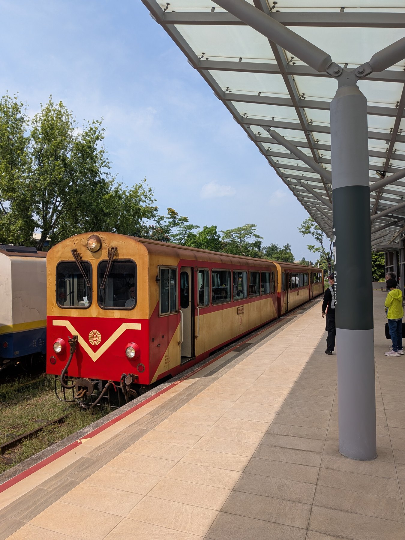 Red Alishan Forest Railway train at a platform.