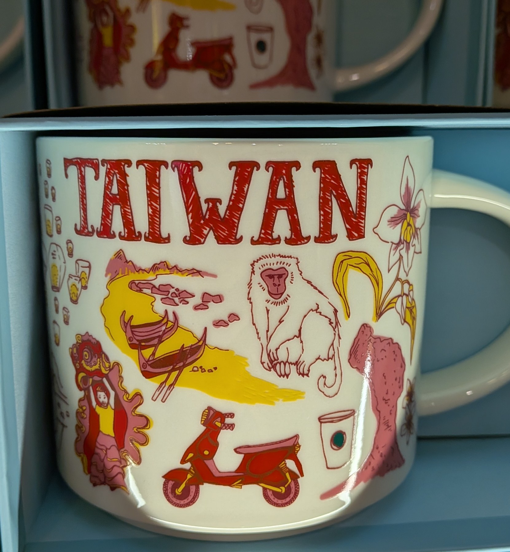 Taiwan souvenir mugs stacked on a shelf.